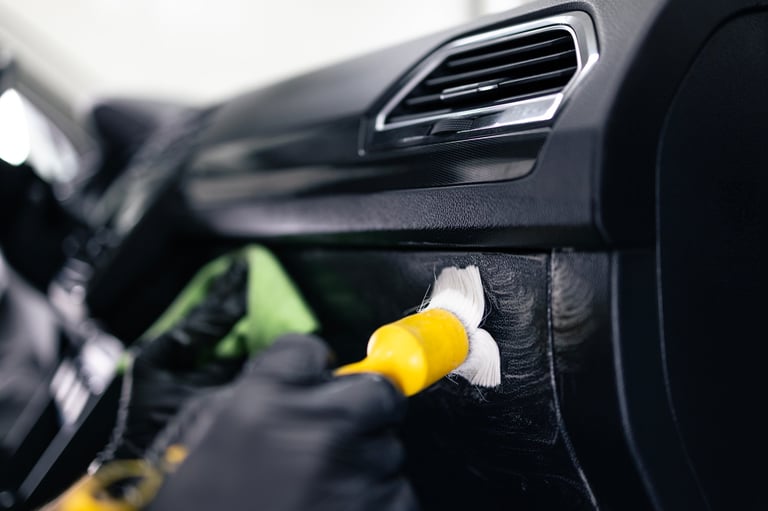 Cleaning automobile interior with brush tool